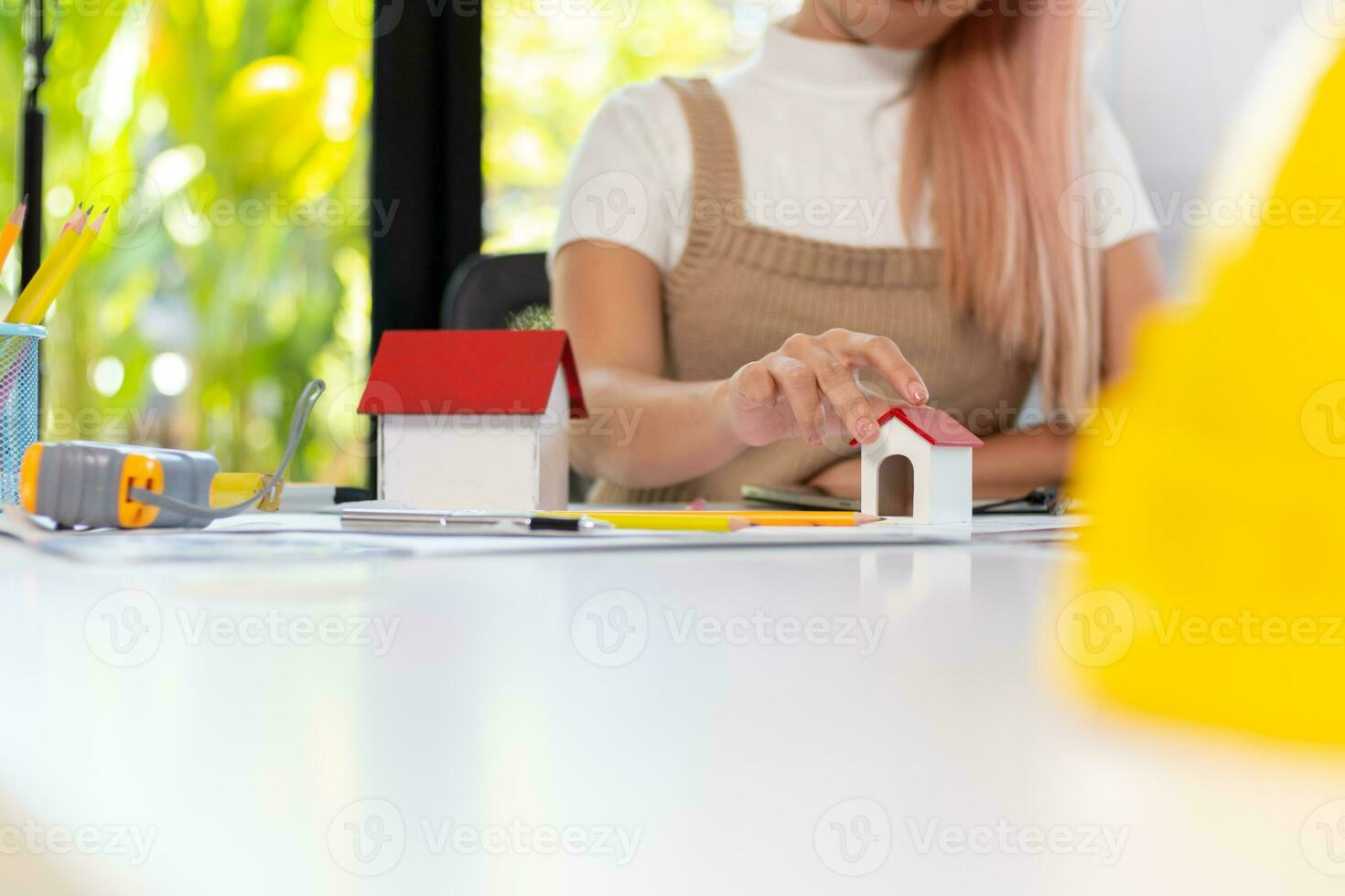 Engineers and designers are discussing the layout of the house and the construction schedule to be completed on schedule. House construction ideas with a team of professional engineers and designers. photo