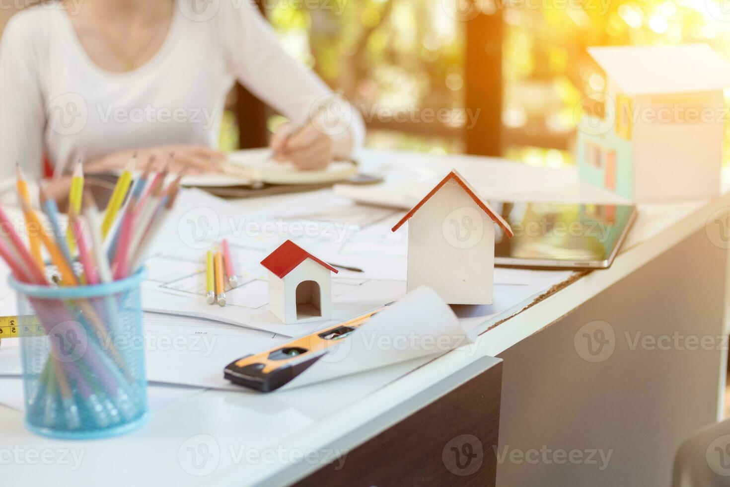 Engineers and designers are discussing the layout of the house and the construction schedule to be completed on schedule. House construction ideas with a team of professional engineers and designers. photo