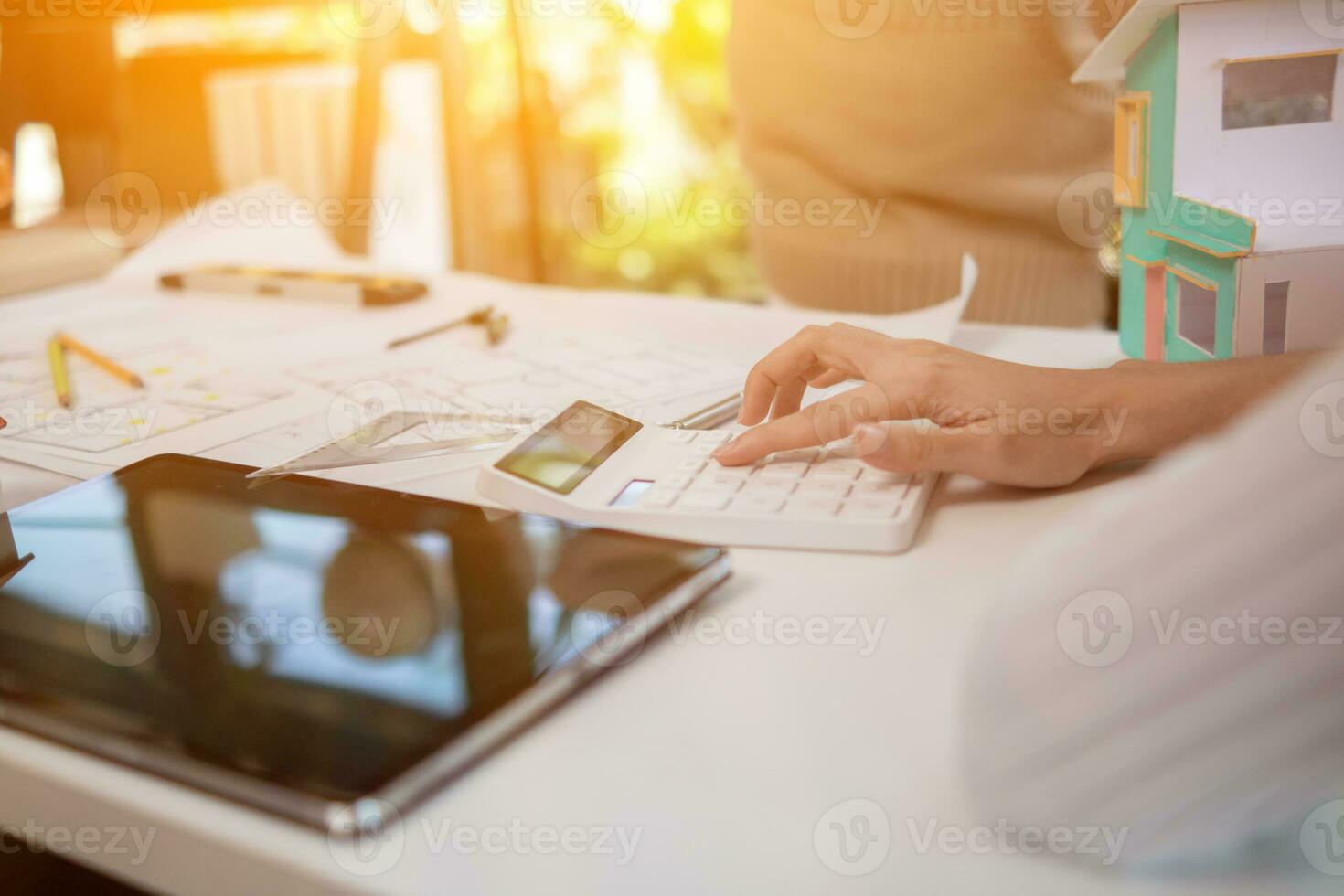 Engineers and designers are discussing the layout of the house and the construction schedule to be completed on schedule. House construction ideas with a team of professional engineers and designers. photo