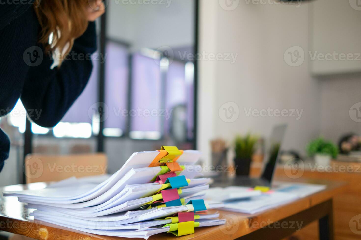 Businesswoman hands working on stacks of paper documents to search and review documents piled on table before sending them to board of directors to use  correct documents in meeting with Businessman photo