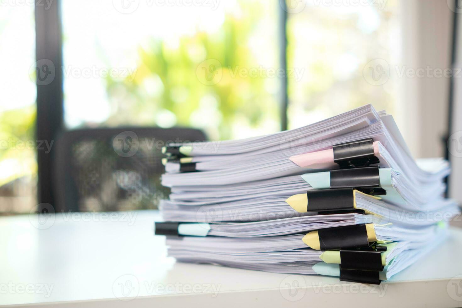 Businesswoman hands working on stacks of paper documents to search and review documents piled on table before sending them to board of directors to use  correct documents in meeting with Businessman photo