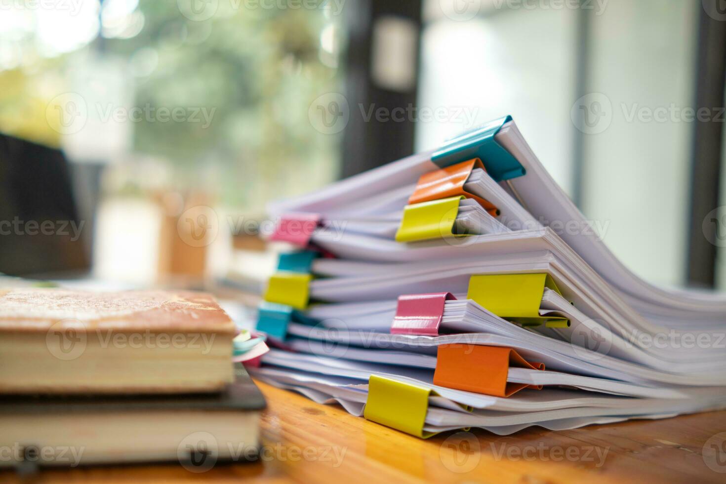 Businesswoman hands working on stacks of paper documents to search and review documents piled on table before sending them to board of directors to use  correct documents in meeting with Businessman photo