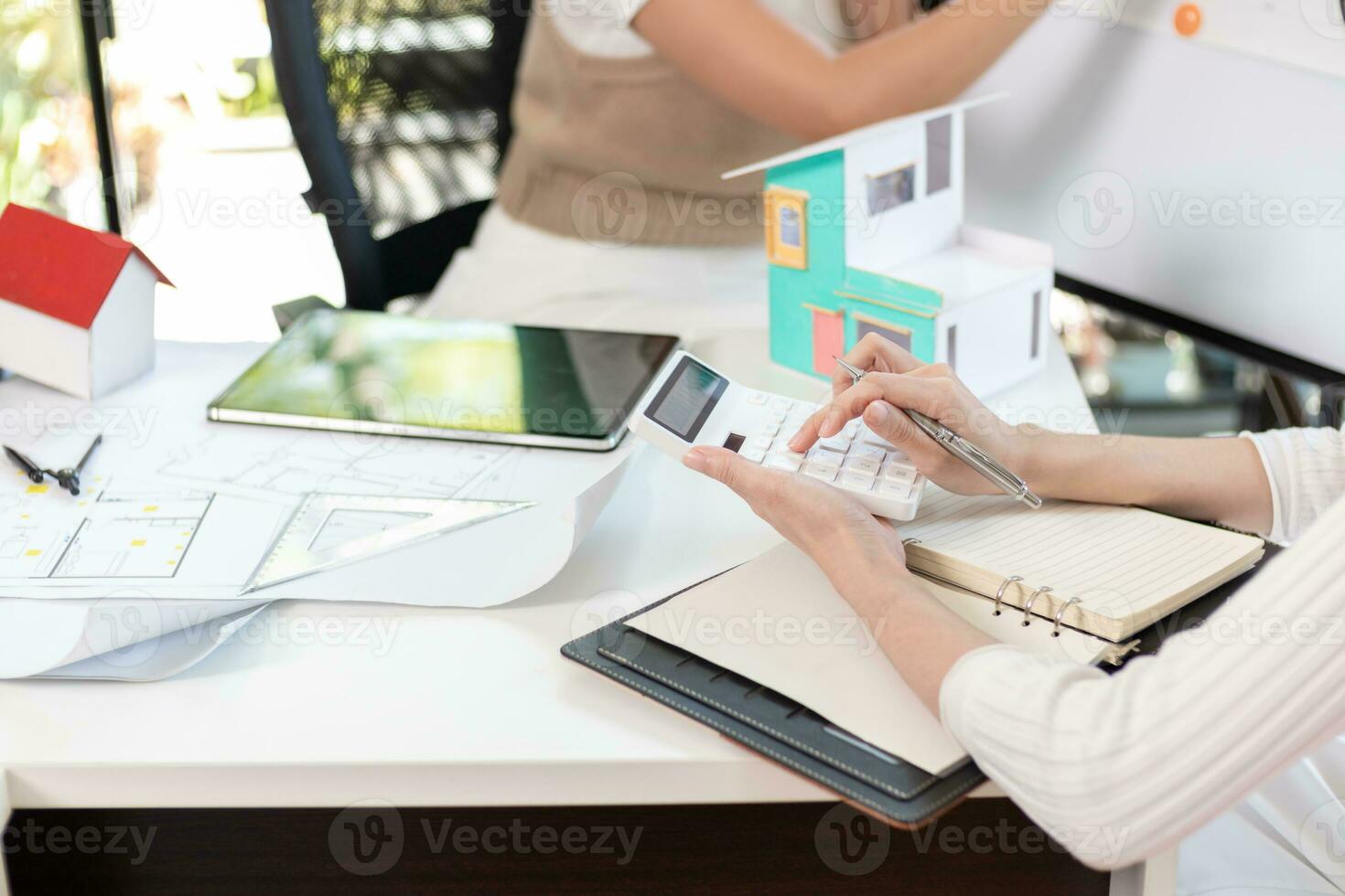 Engineers and designers are discussing the layout of the house and the construction schedule to be completed on schedule. House construction ideas with a team of professional engineers and designers. photo
