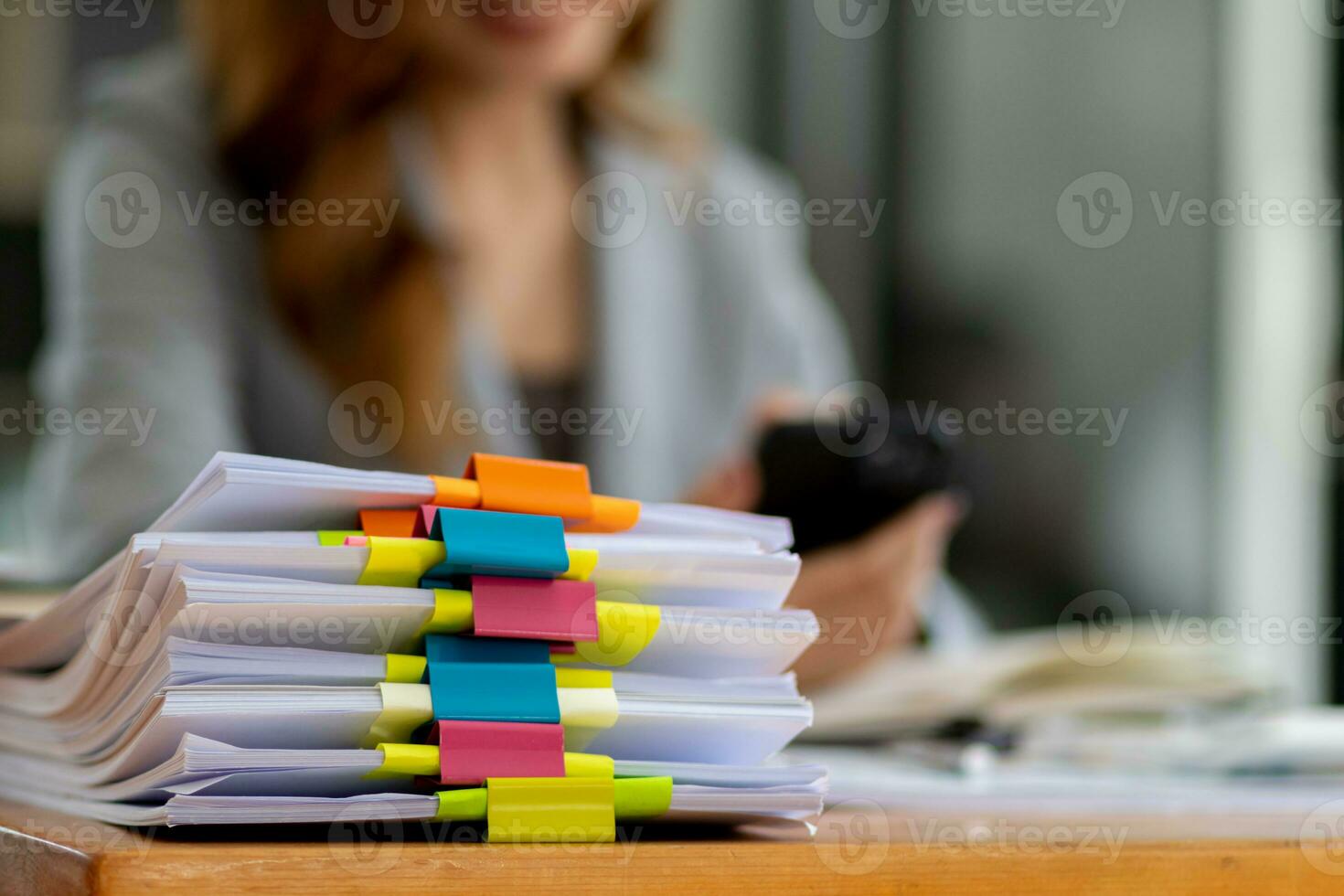 Businesswoman hands working on stacks of paper documents to search and review documents piled on table before sending them to board of directors to use  correct documents in meeting with Businessman photo