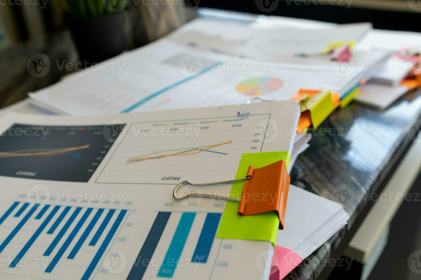 Businesswoman hands working on stacks of paper documents to search and review documents piled on table before sending them to board of directors to use  correct documents in meeting with Businessman photo