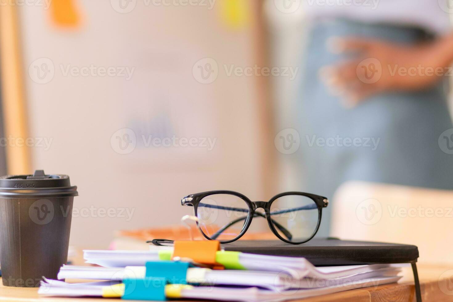 Businesswoman hands working on stacks of paper documents to search and review documents piled on table before sending them to board of directors to use  correct documents in meeting with Businessman photo