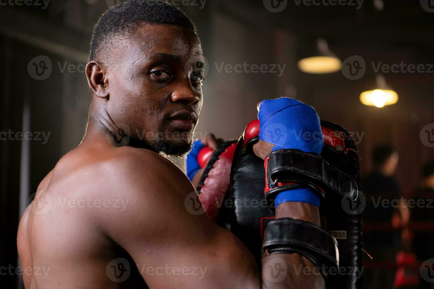 Portrait of boxer's training partner self-defense equipment must be used in order for the boxer to fully use the weapon against him. photo
