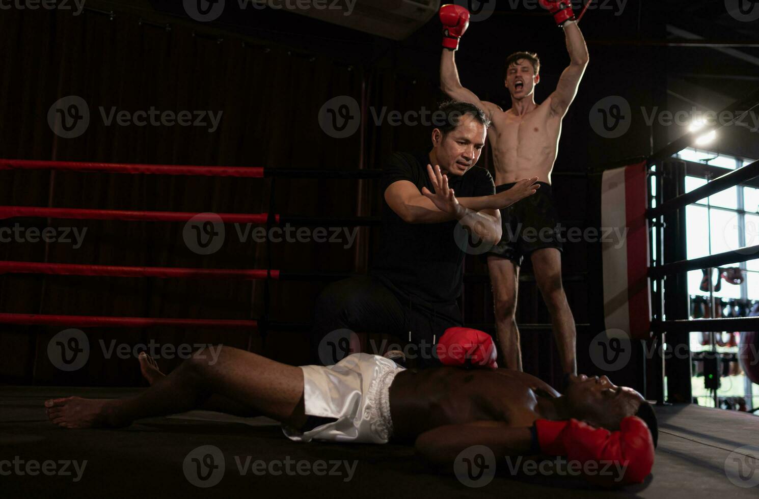 The referee stopped the fight. When one boxer is knocked out and cannot stand up to fight within a count of one to ten from the referee, Muay Thai, Thai martial arts. photo