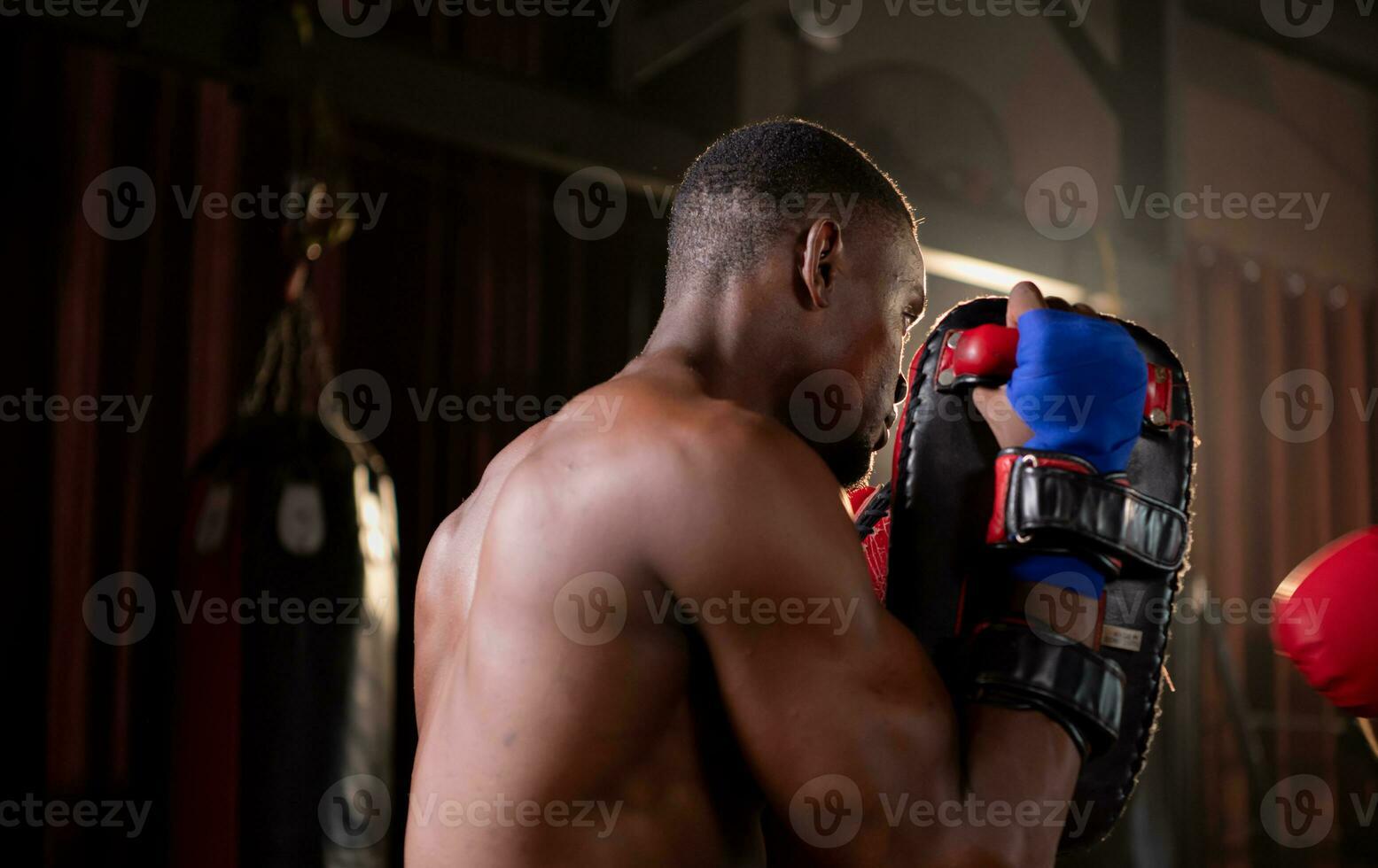 Portrait of boxer's training partner self-defense equipment must be used in order for the boxer to fully use the weapon against him. photo