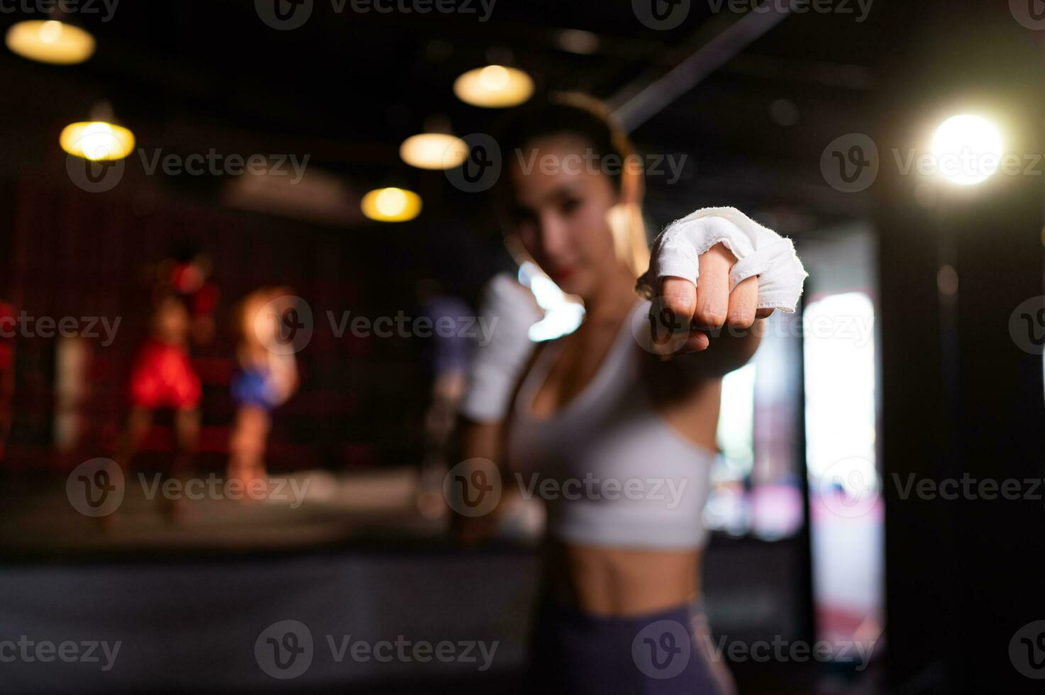 Portrait of woman learning Muay Thai to build up the strength of the body and use it for self-defense. Are using hand wraps before putting on boxing gloves for boxing photo