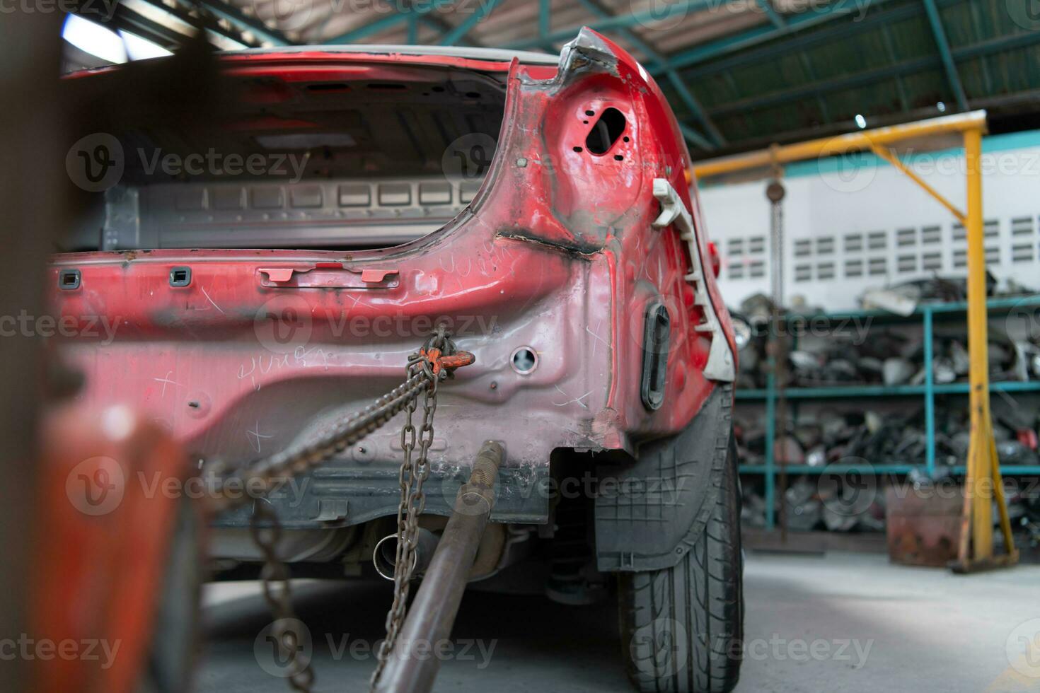 The car crashed so hard that the car body collapsed into distortion. A car body puller is required to restore the car body to its original shape. photo
