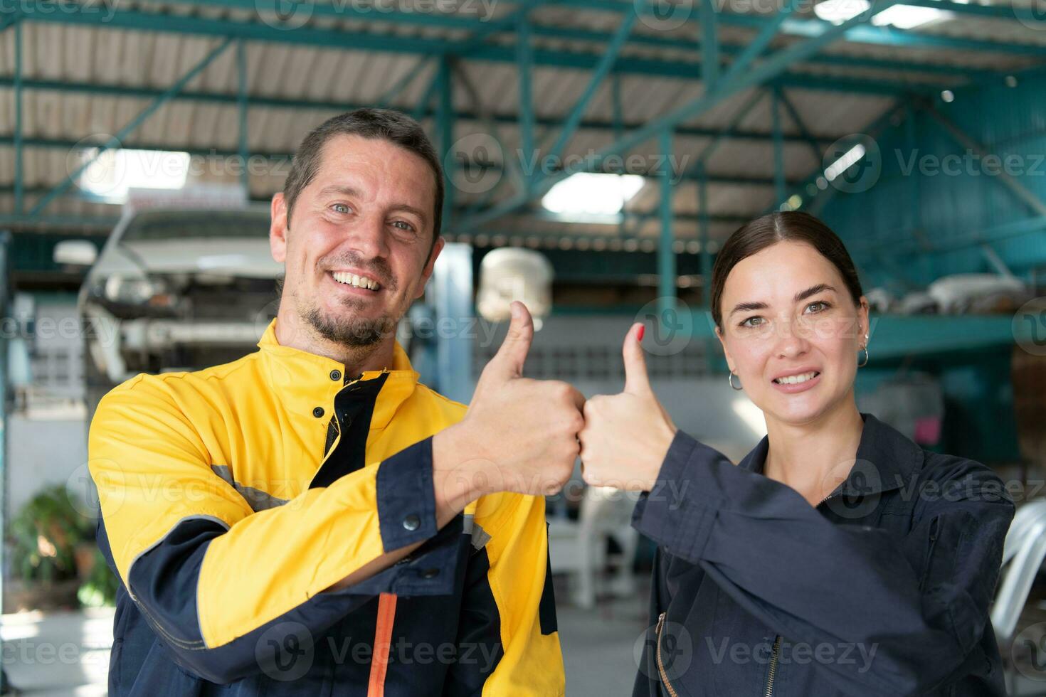 Portrait of engineer and auto mechanic with working on engine repairs in car garages photo