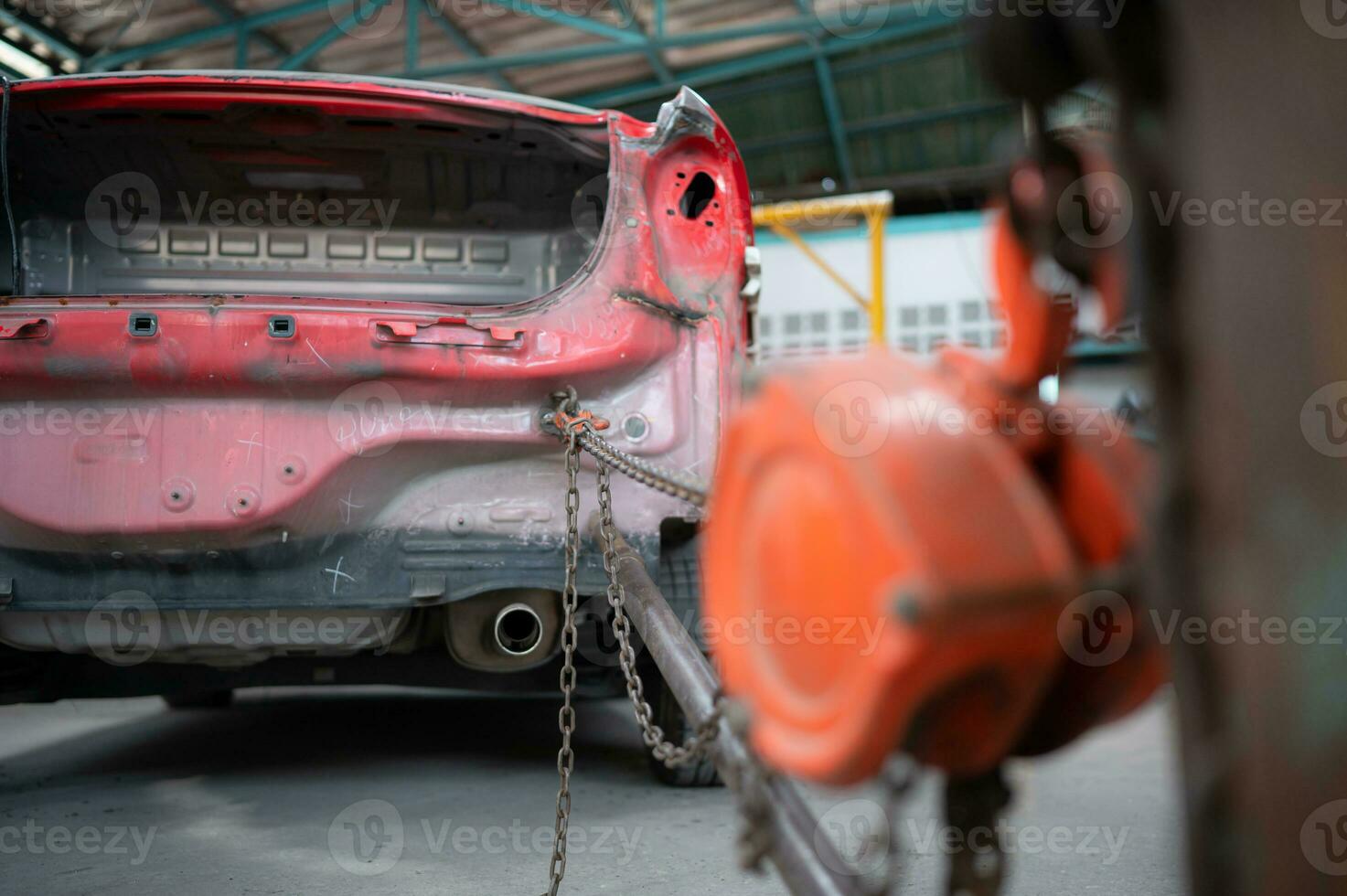 The car crashed so hard that the car body collapsed into distortion. A car body puller is required to restore the car body to its original shape. photo