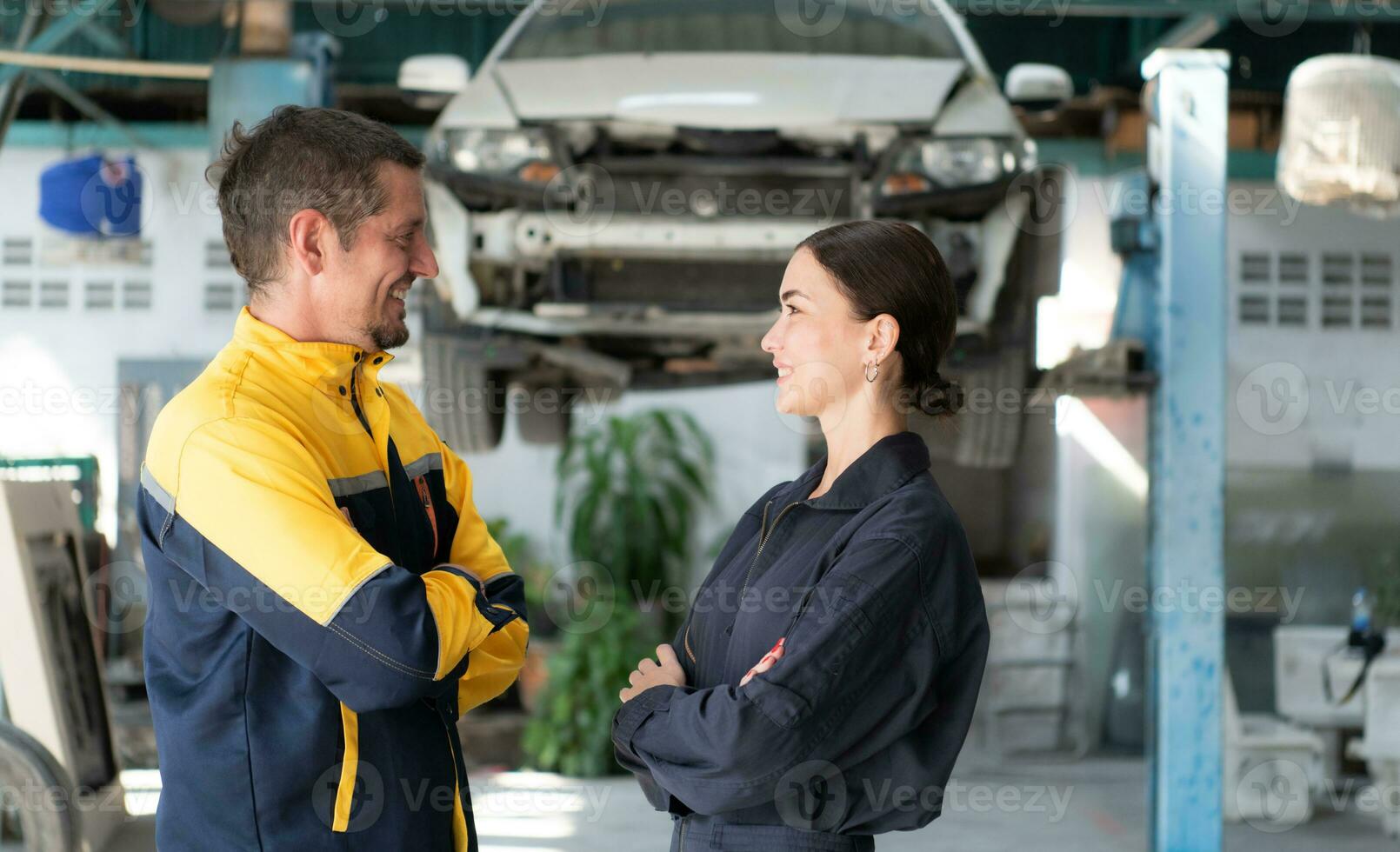 Portrait of engineer and auto mechanic with working on engine repairs in car garages photo