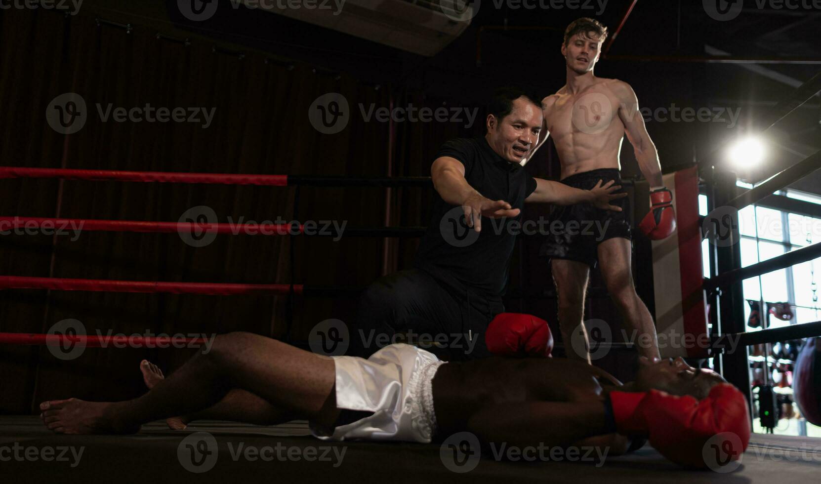 The referee stopped the fight. When one boxer is knocked out and cannot stand up to fight within a count of one to ten from the referee, Muay Thai, Thai martial arts. photo