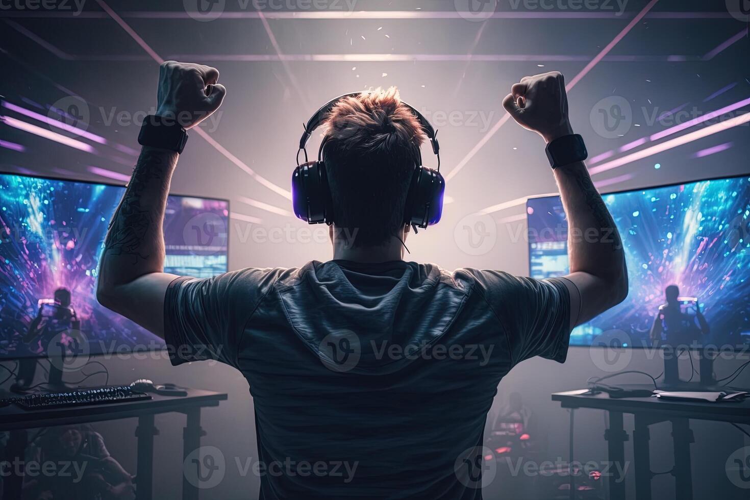 Professional eSports gamer rejoices in the victory in red blue illuminated game room. Gamer celebrating victory. Winning an eSports game. . Electronic sports player rejoices victory photo