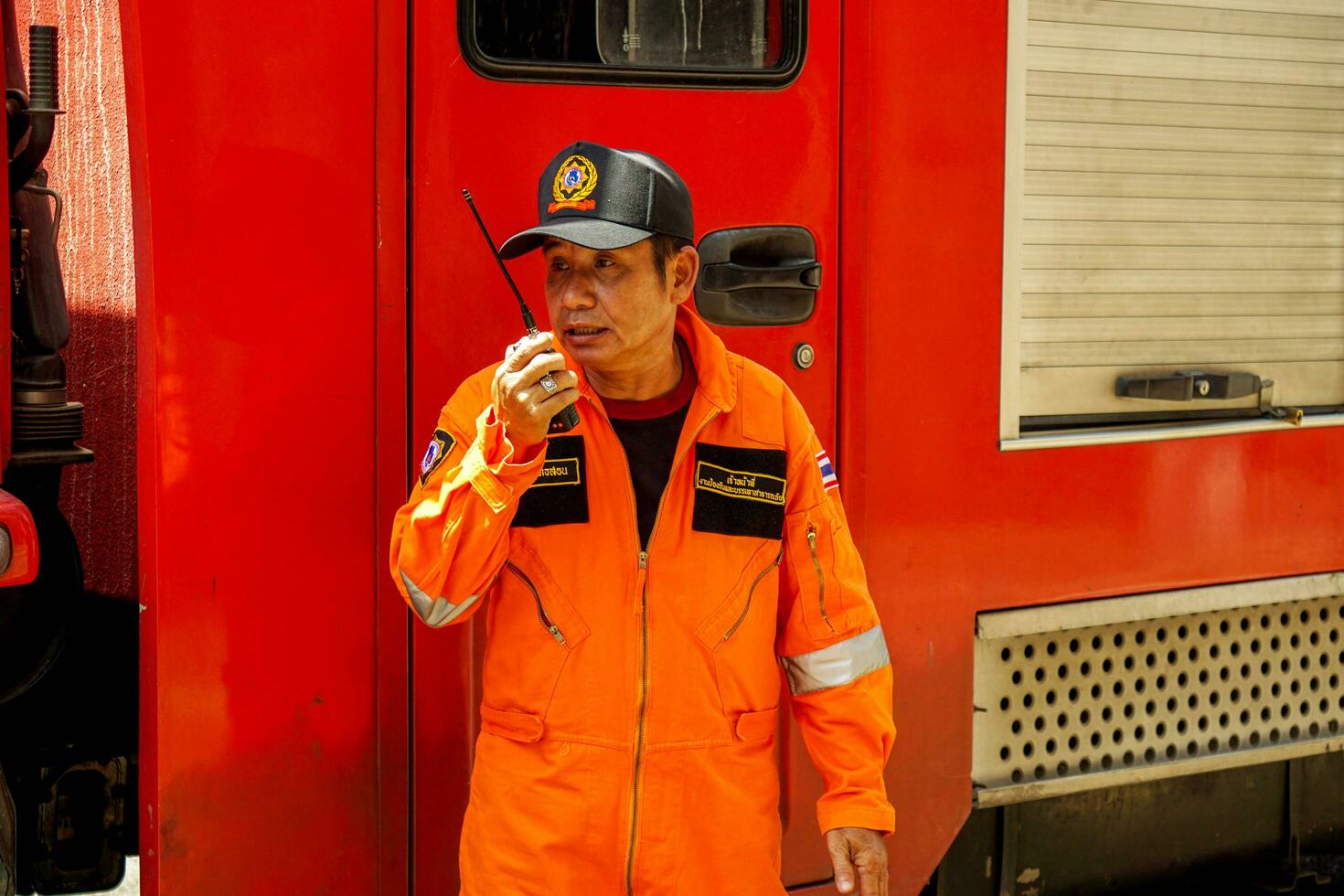 Lampang, Thailand, 2018 - Head of firefighters unit hold and using radio talky walky command fire control in the real annual rehearsal fire drill in urban city. photo