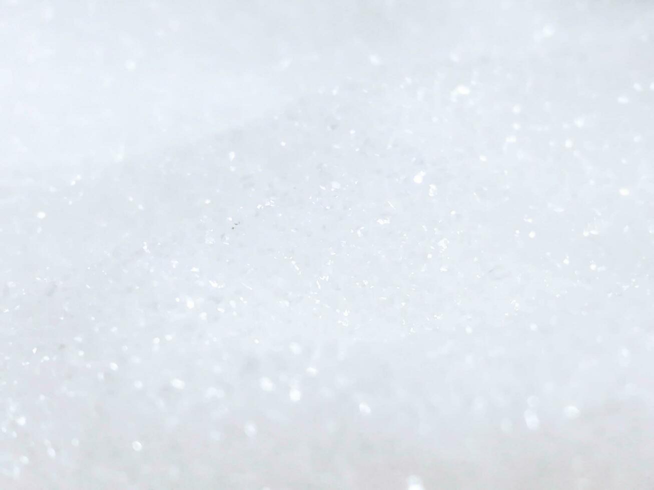 Closeup blurred and refection lighting heap of white sugar background and wallpaper. photo