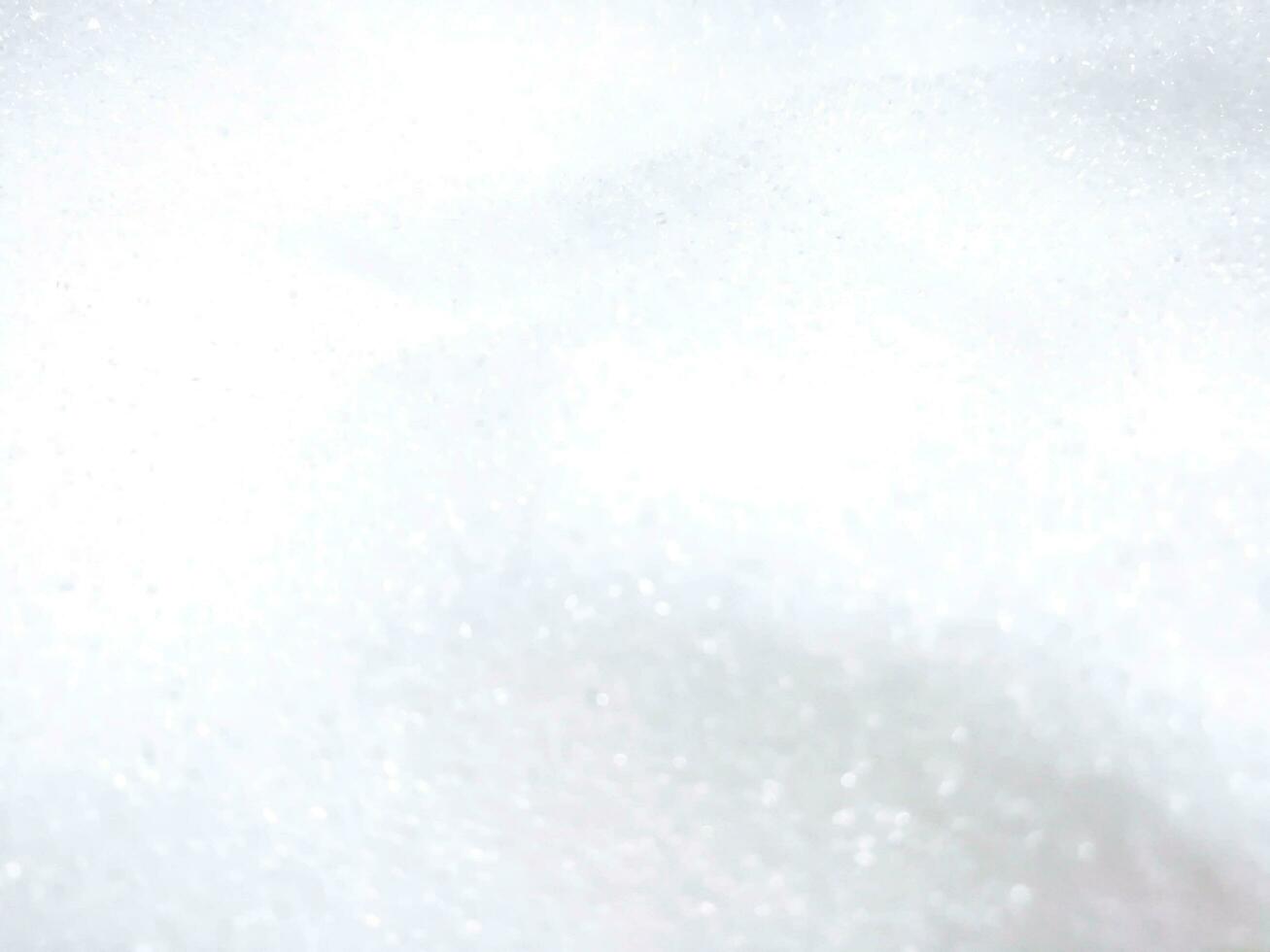 Closeup blurred and refection lighting heap of white sugar background and wallpaper. photo