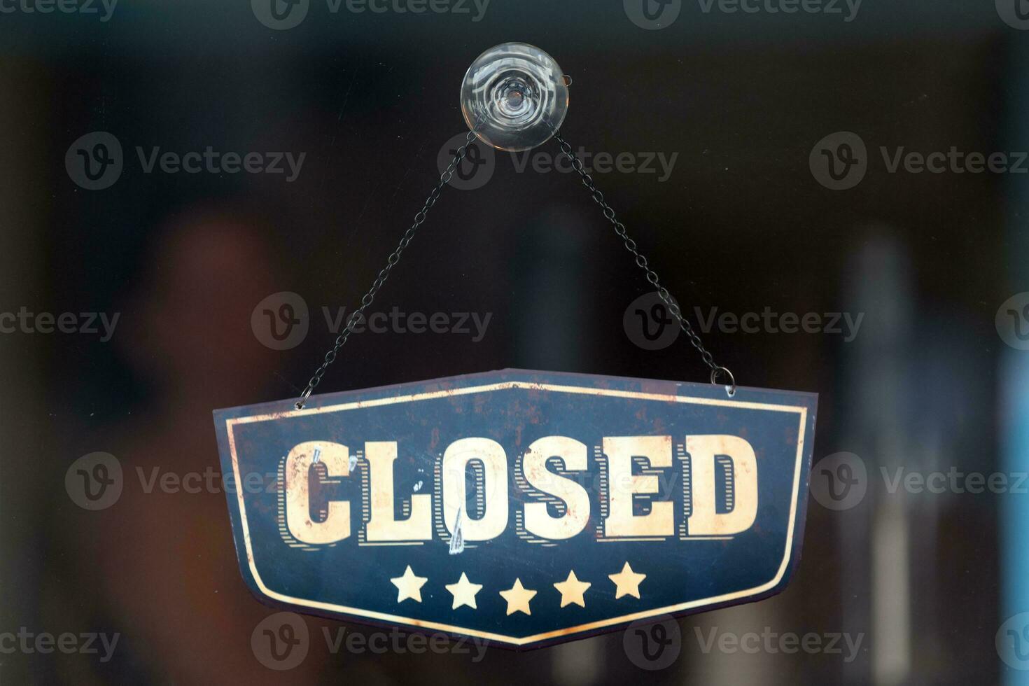 Closed sign in the window of a shop photo