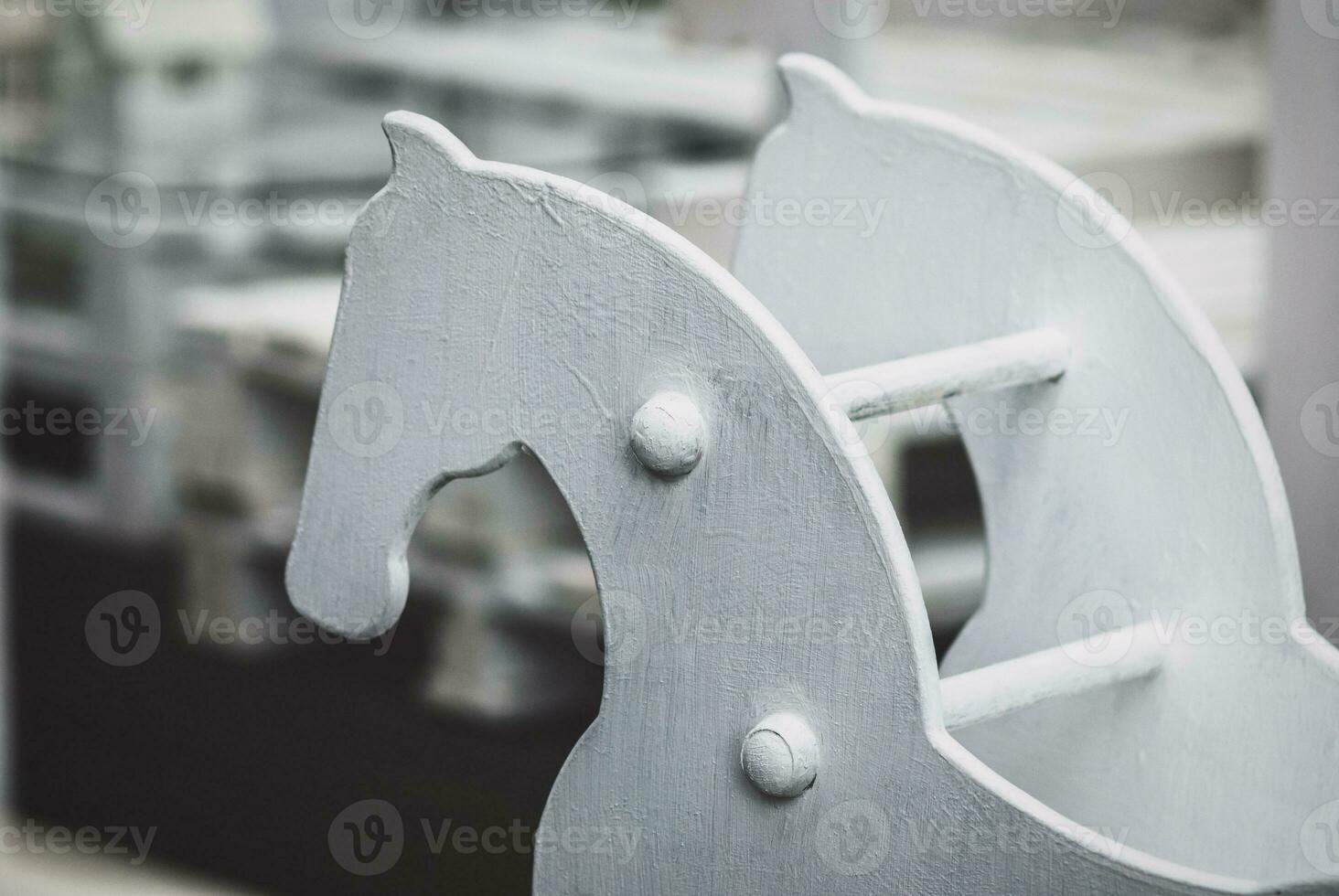 old wooden hobby-horse against a playground photo