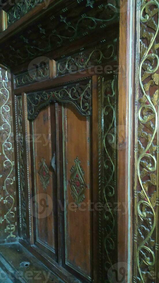 Javanese traditional door with carved carvings made of wood photo