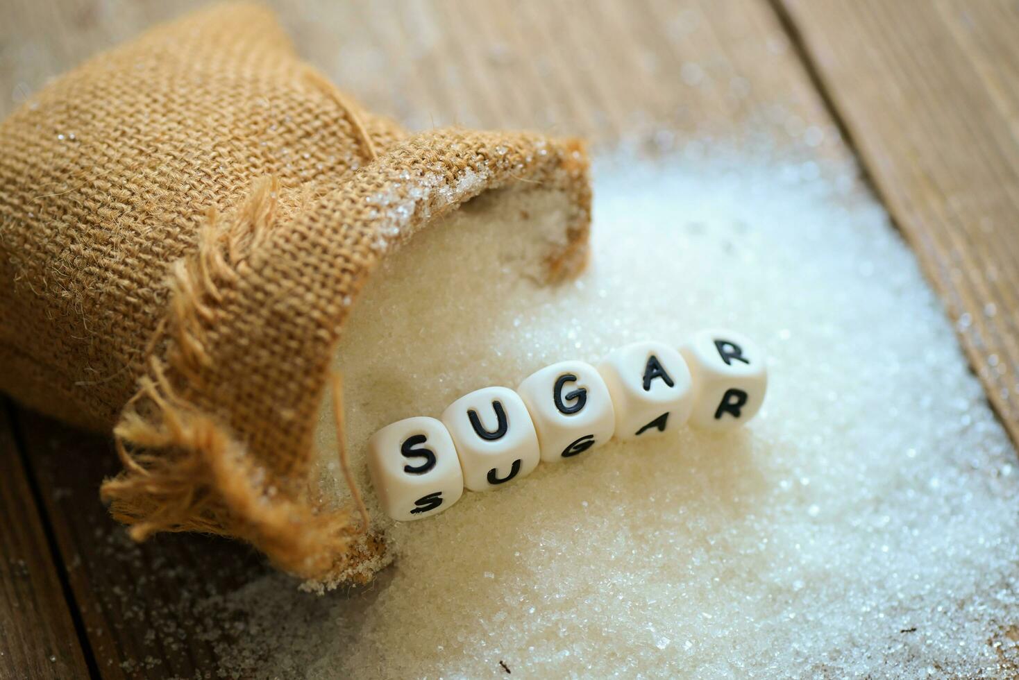 white sugar for food and sweets dessert candy heap of sweet sugar crystalline granulated, Sugar on sack and wooden background photo