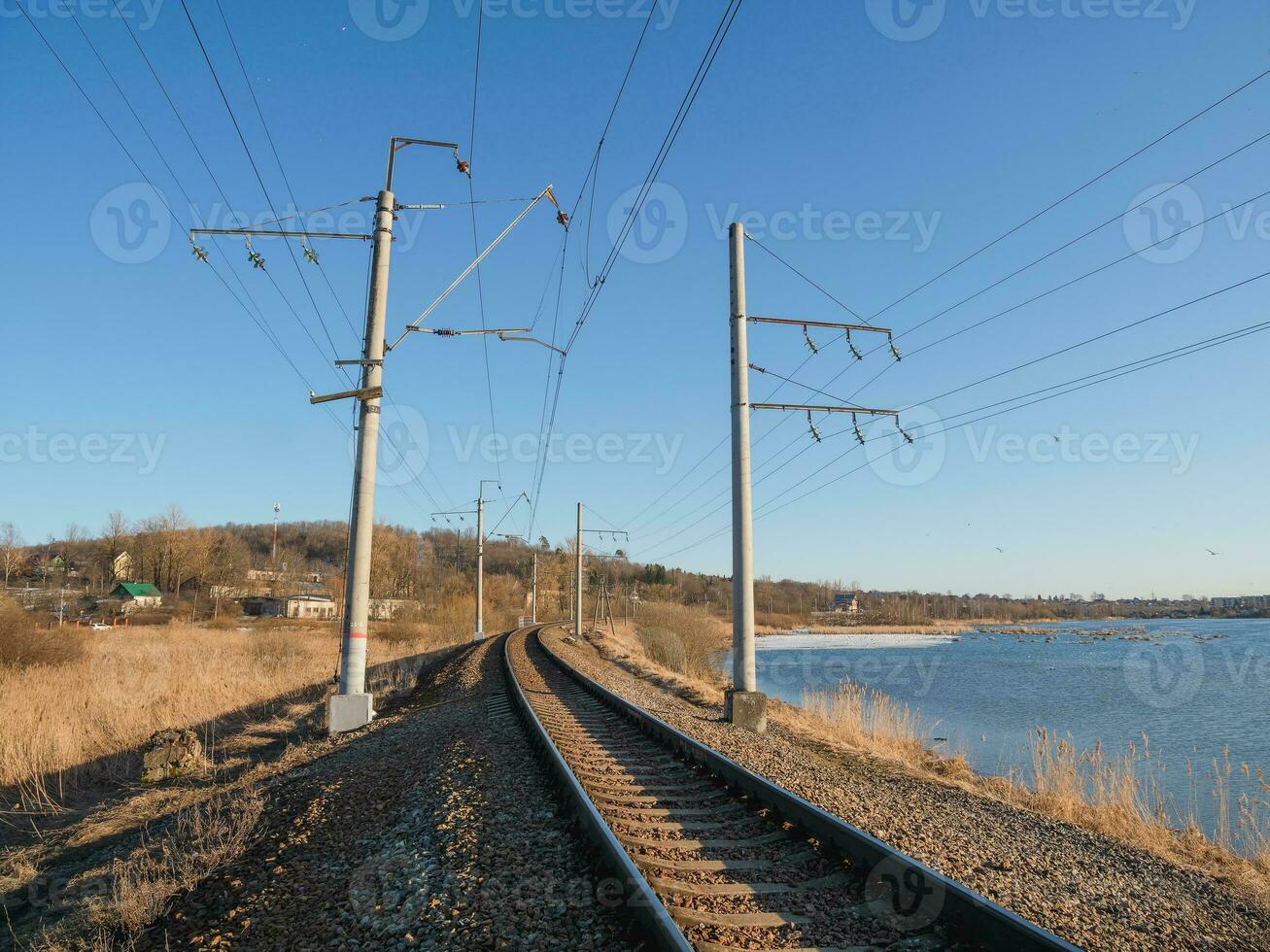 Empty railway track, single rail. Railway track turns and twists between out of focus hills background. Empty rounding and turning single track of railways. photo