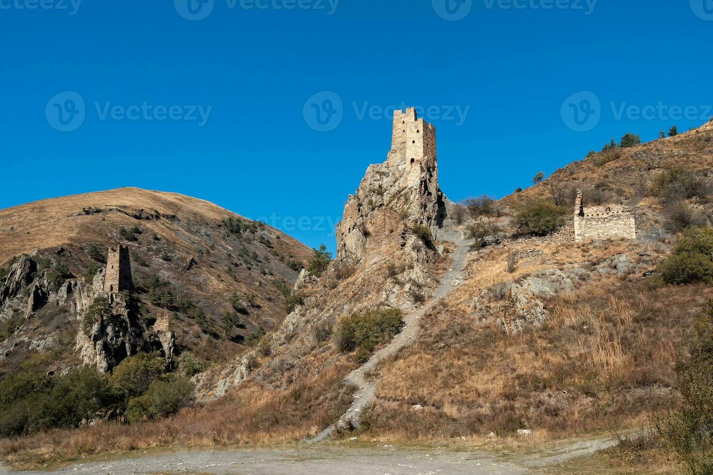 soleado tarde en el Cáucaso montañas. medieval torre complejo vovnushki, uno de el auténtico medieval tipo castillo torre pueblos, situado en el extremidad de el montaña rango en ingushetia foto
