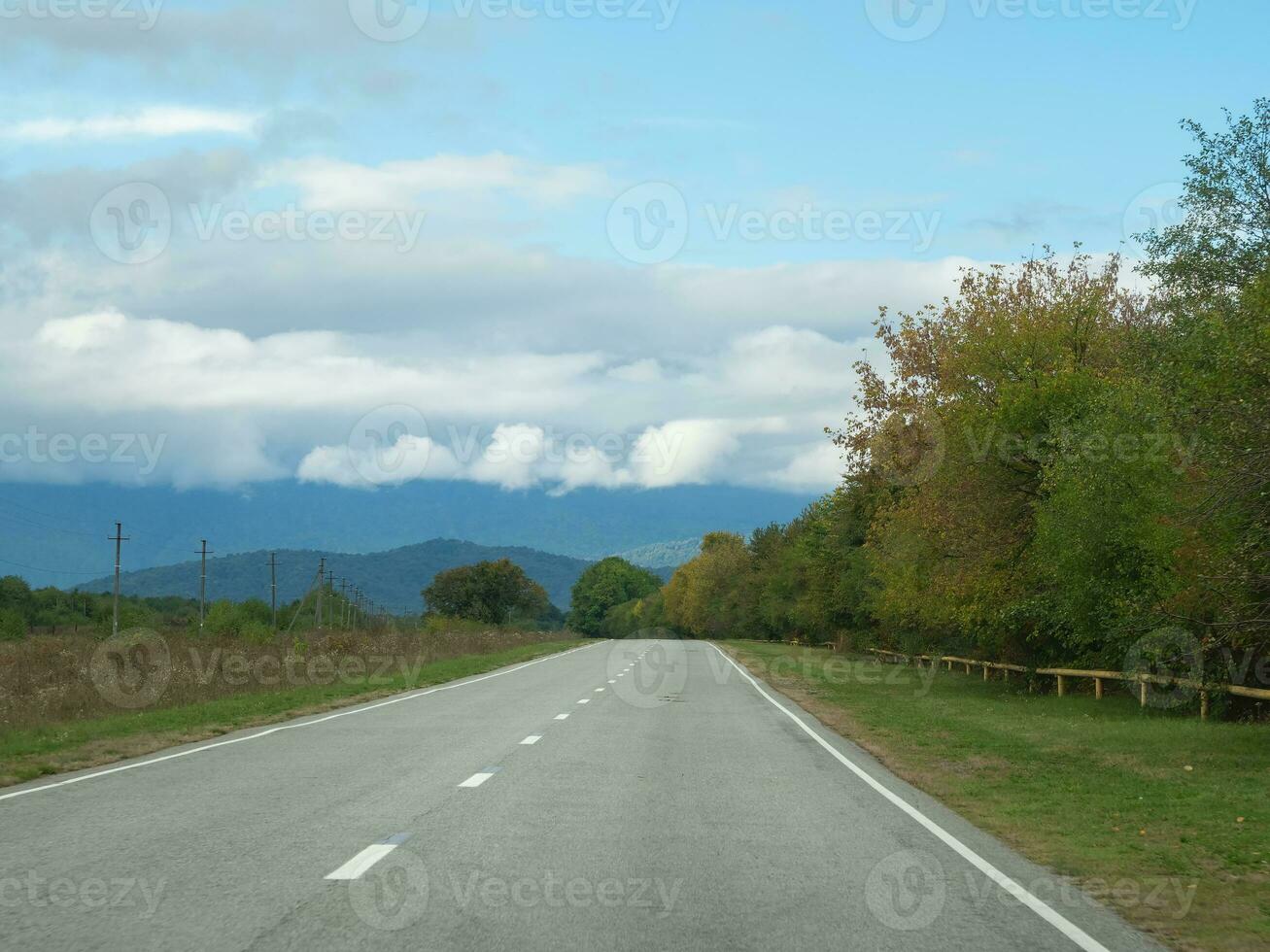 Highway through the autumn forest natural way concept, road to the caucasian forest nature field, relaxing with ecological environment. Mountain Digoria is a national park in North Ossetia photo