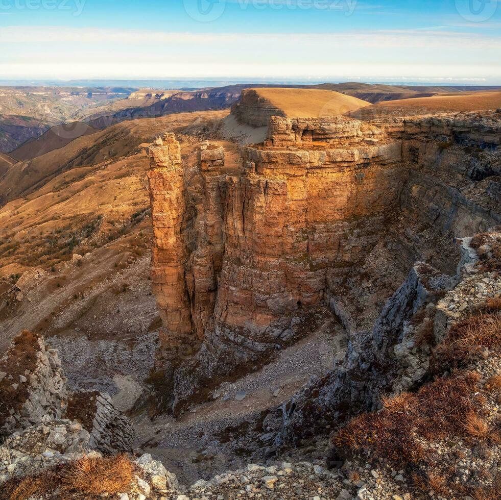 Amazing view of Bermamyt plateau rocks on sunny day. Caucasus Mountains on the edge of a cliff in the distance. Atmospheric landscape with silhouettes of mountains. Karachay-Cherkessia, Russia. photo