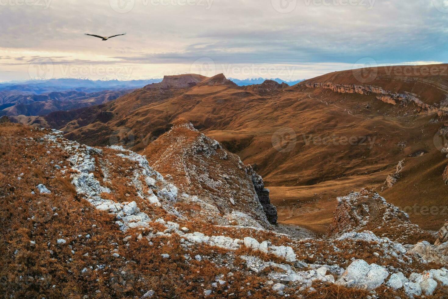 Dawn view of Bermamyt plateau rocks. Mountains on the edge of a cliff in the distance on dramatic morning. Atmospheric landscape with silhouettes of mountains. Karachay-Cherkessia, Caucasus, Russia. photo