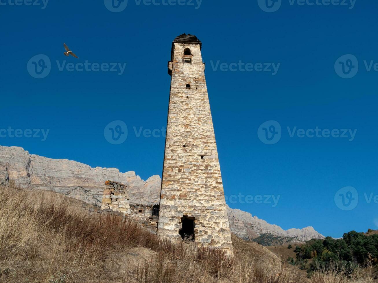 Ancient battle tower of Ingushetia. The medieval battle complex Pyaling is set on the top of the range. Located in the Dzheyrakh region. Russia. photo