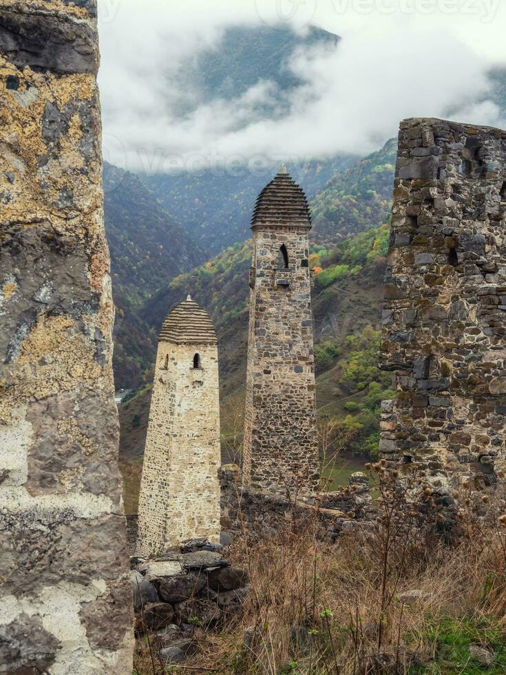 Battle towers Erzi in the Jeyrah gorge. Medieval tower complex Erzi, one of the largest medieval castle-type tower villages, located on the extremity of the mountain range in Ingushetia, Russia. photo