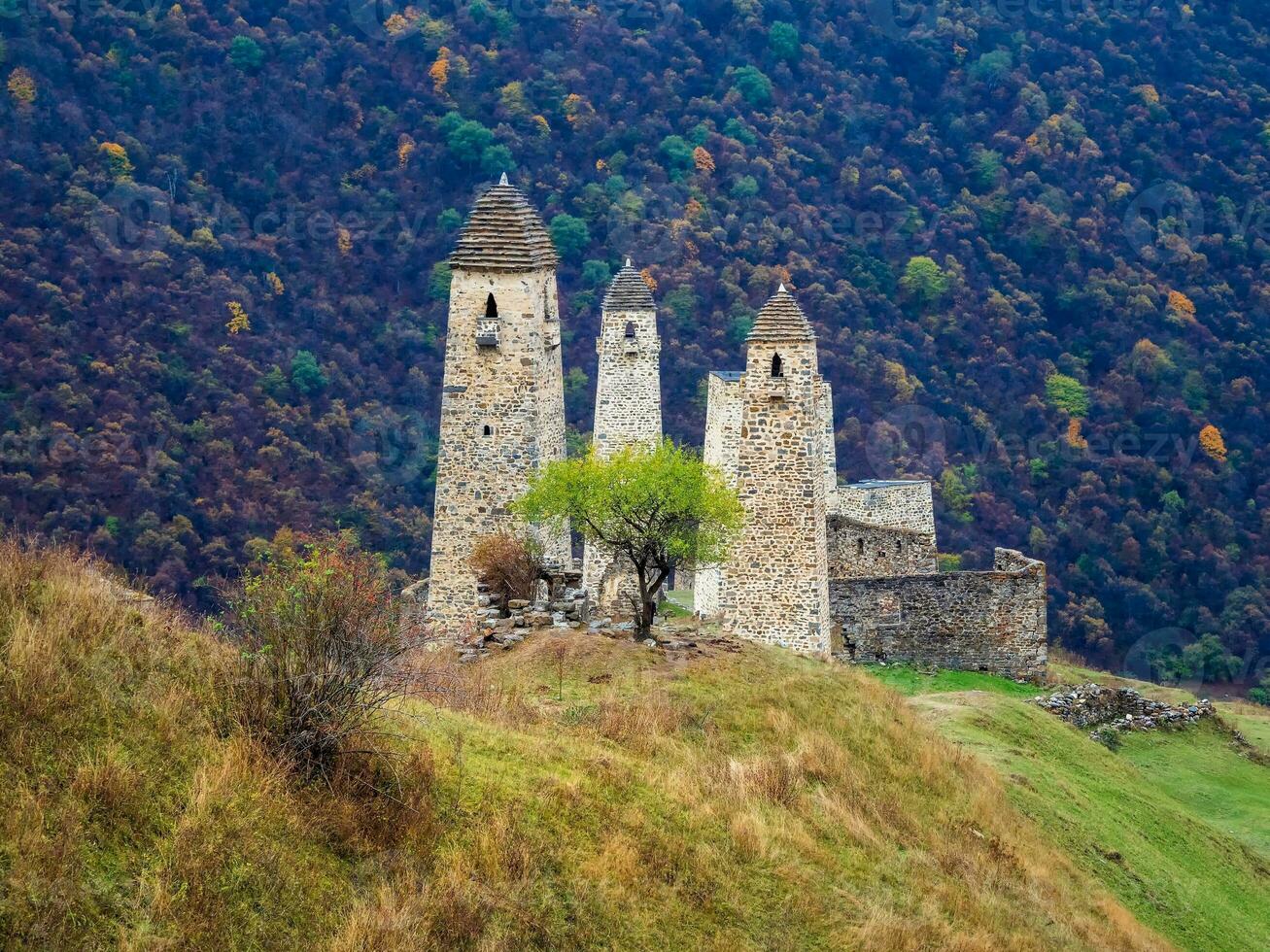 Majestic battle towers of Ingushetia. Beautiful historical monument, tourist attraction. Amazing medieval tower complex Erzi, one of the largest medieval castle-type tower villages. photo