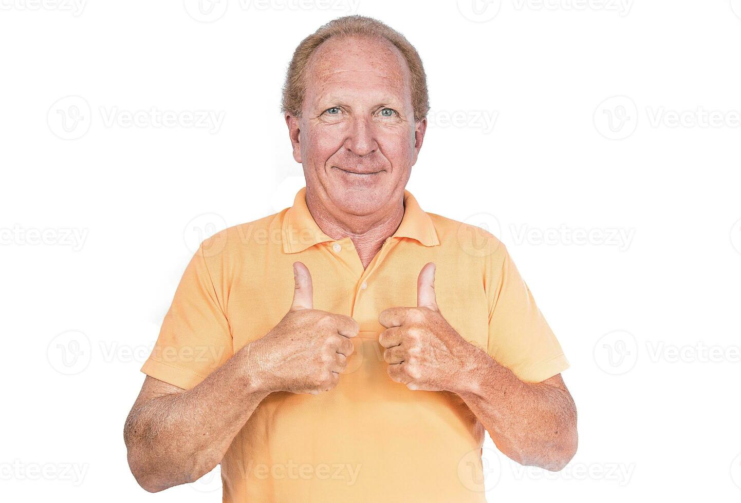 Handsome old man in orange polo-shirt shows thumb up photo