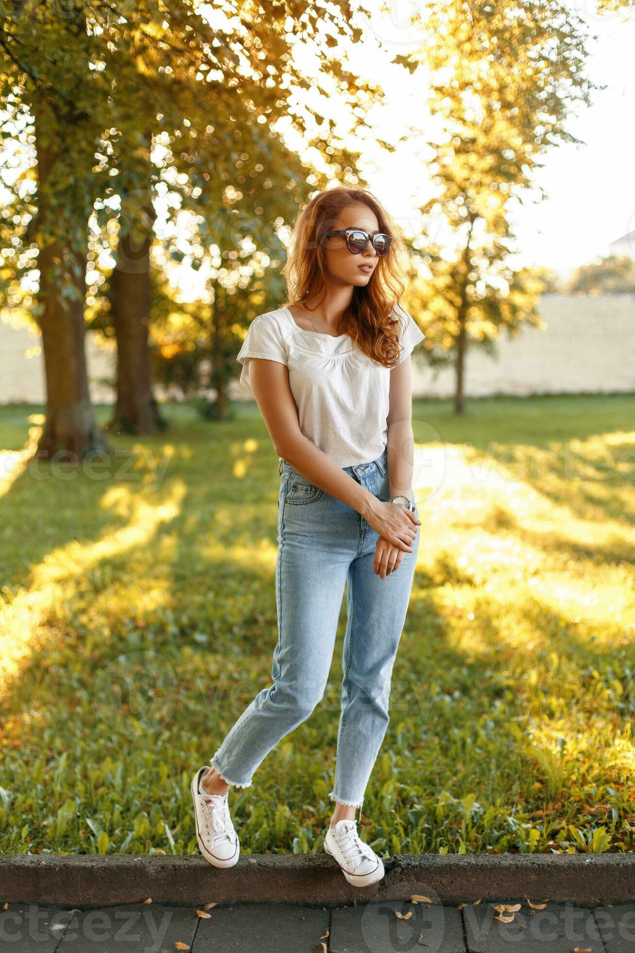 Smiling Woman in Shirt and Jeans Posing near Stone Wall · Free Stock Photo-sonthuy.vn