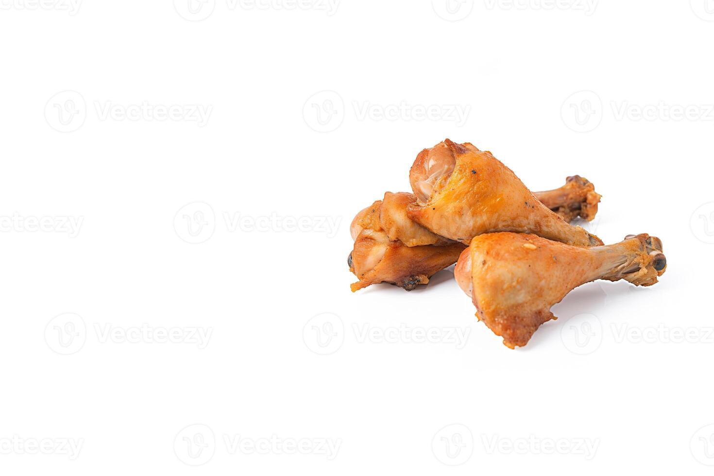 Delicious baked chicken drumsticks in honeymustard marinade isolated on white background with copy space. photo