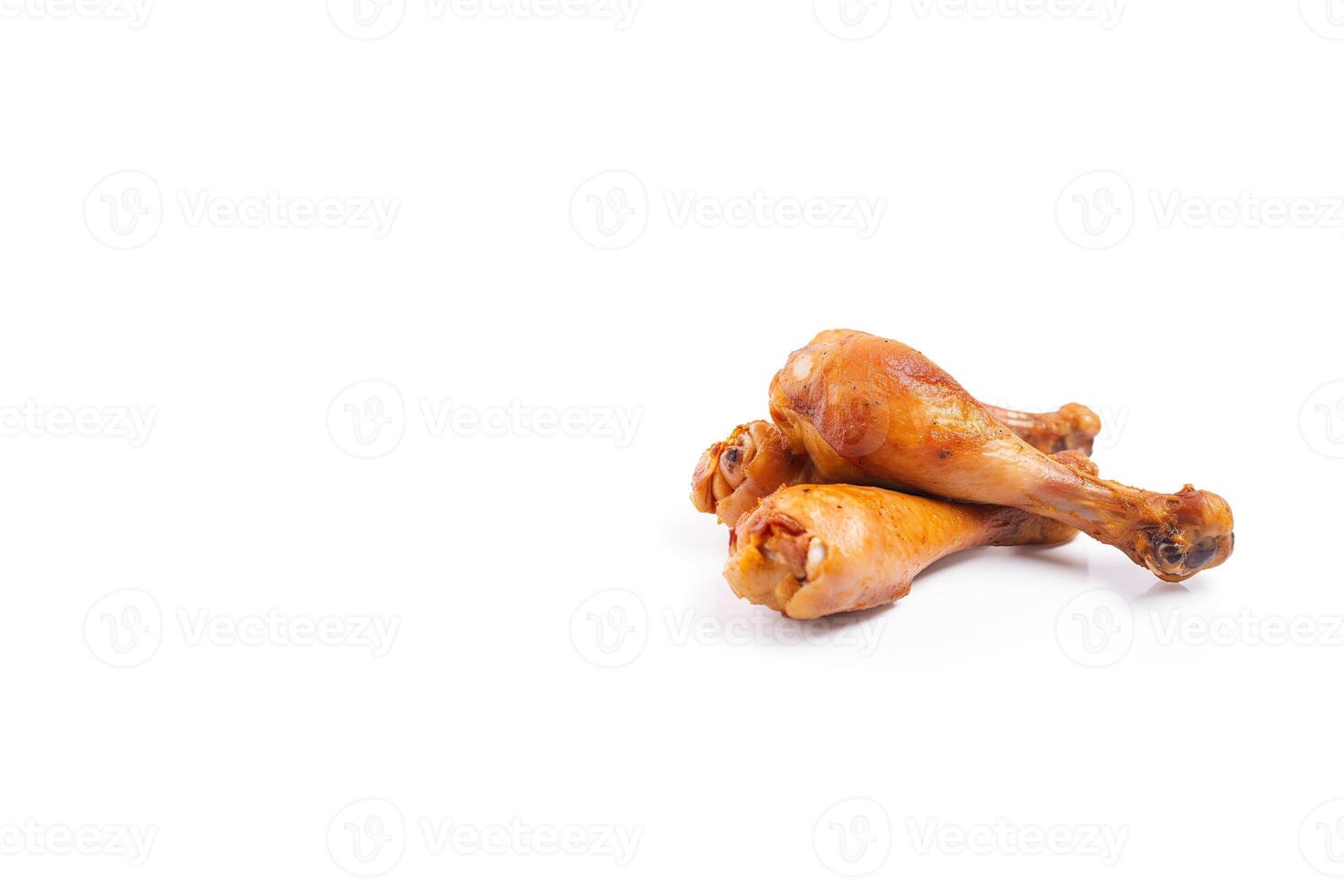 Delicious baked chicken drumsticks in honeymustard marinade isolated on white background with copy space. photo
