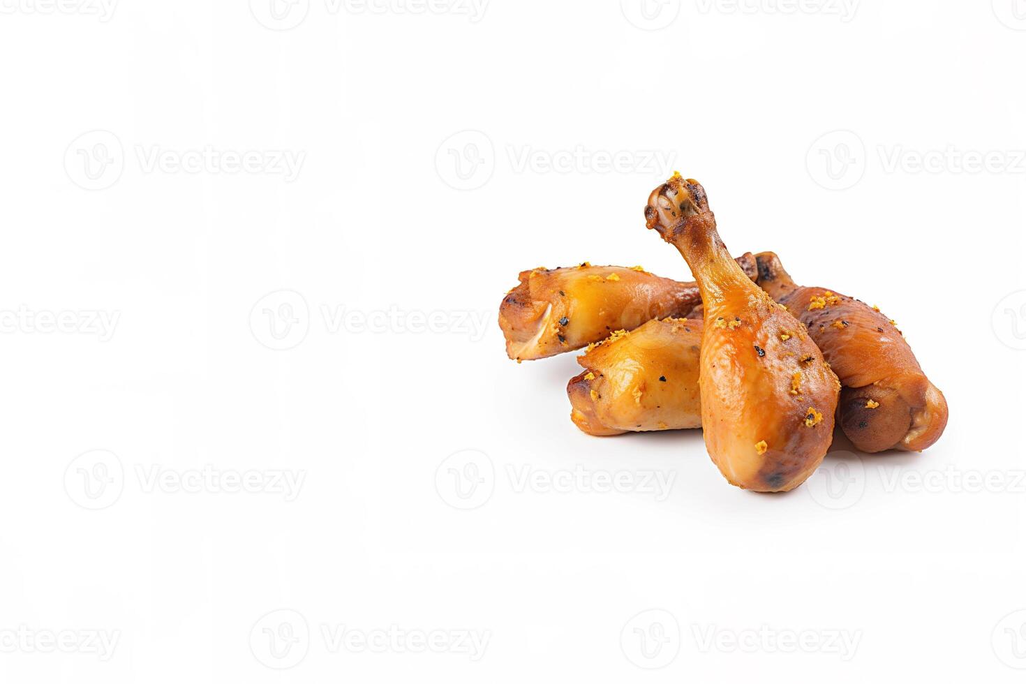 Delicious baked chicken drumsticks in honeymustard marinade isolated on white background with copy space. photo