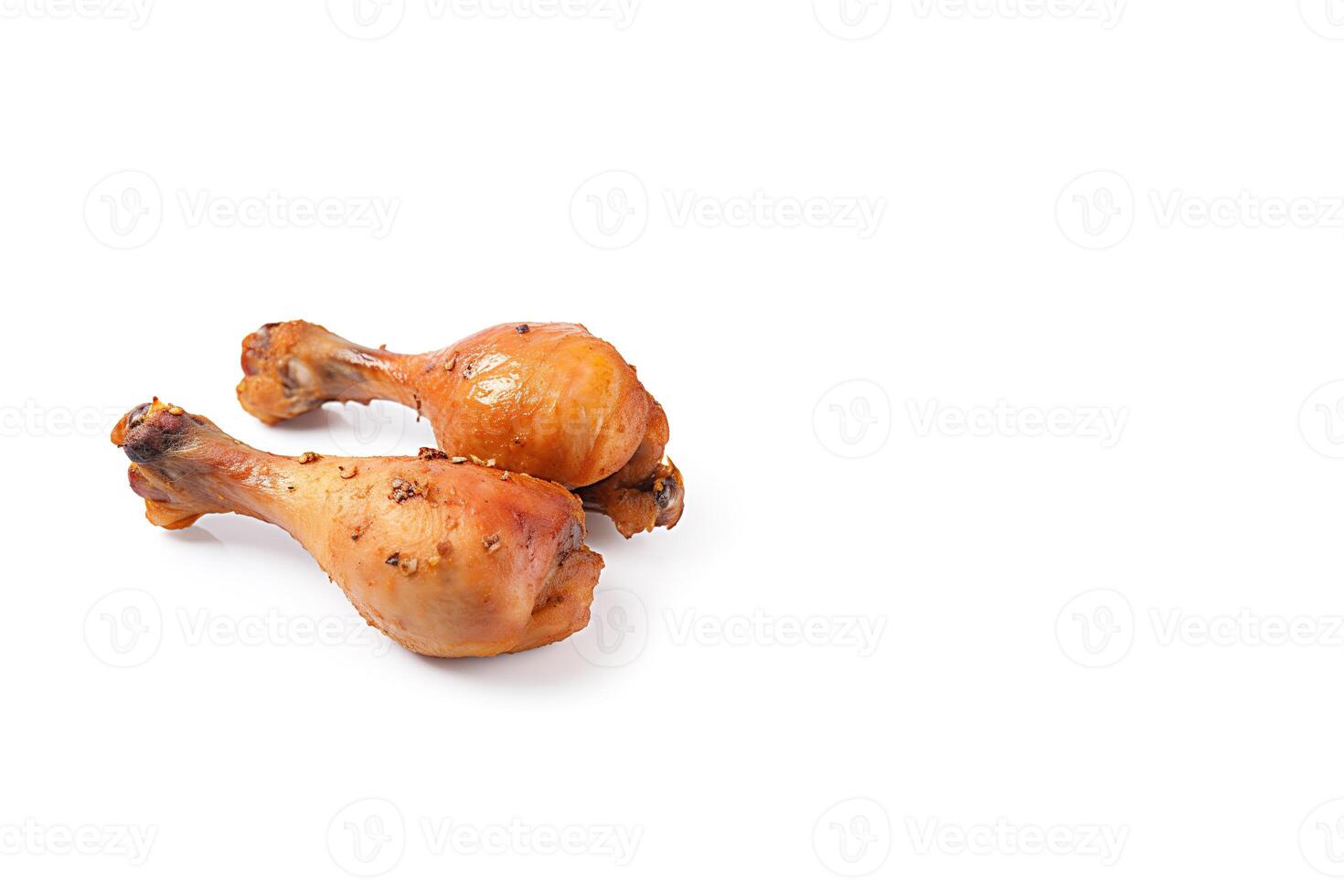 Delicious baked chicken drumsticks in honeymustard marinade isolated on white background with copy space. photo