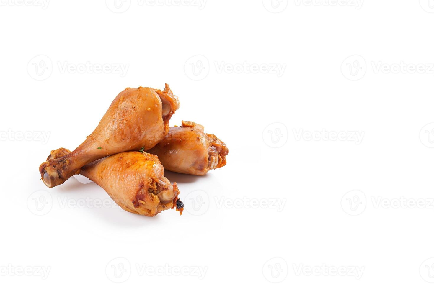 Delicious baked chicken drumsticks in honeymustard marinade isolated on white background with copy space. photo