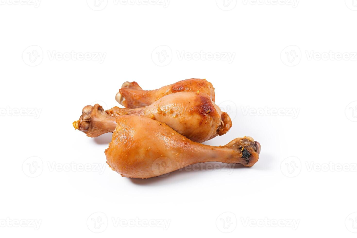 Delicious baked chicken drumsticks in honeymustard marinade isolated on white background. photo