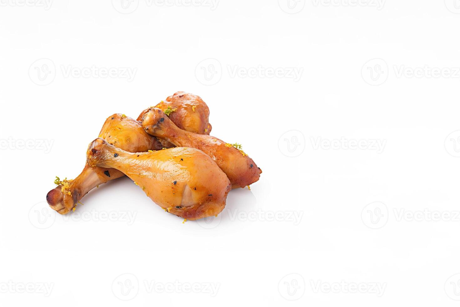 Delicious baked chicken drumsticks in honeymustard marinade isolated on white background with copy space. photo