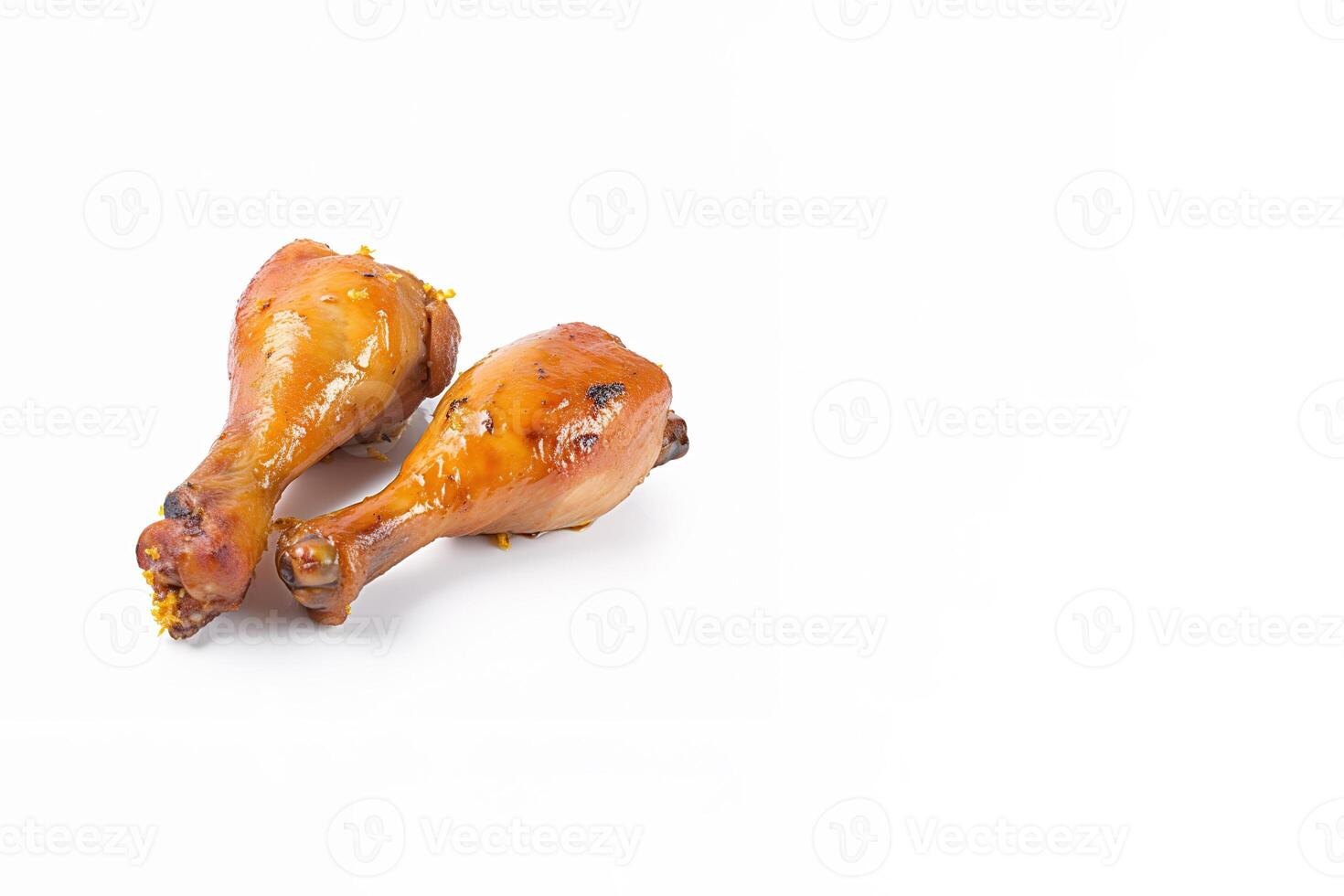 Delicious baked chicken drumsticks in honeymustard marinade isolated on white background with copy space. photo