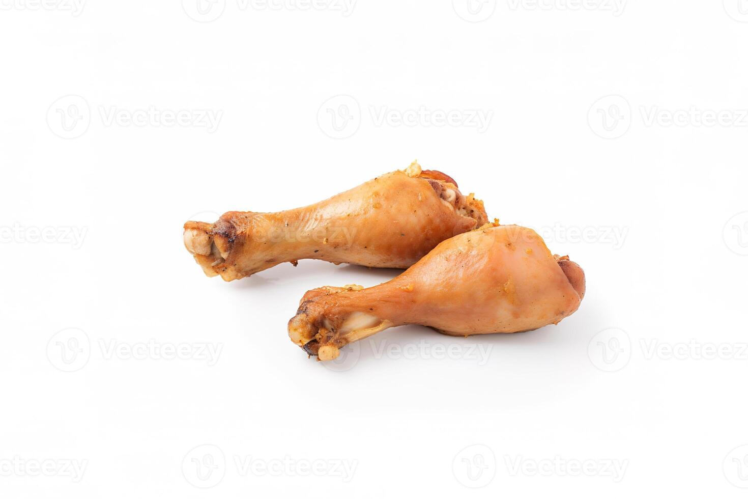 Delicious baked chicken drumsticks in honeymustard marinade isolated on white background. photo