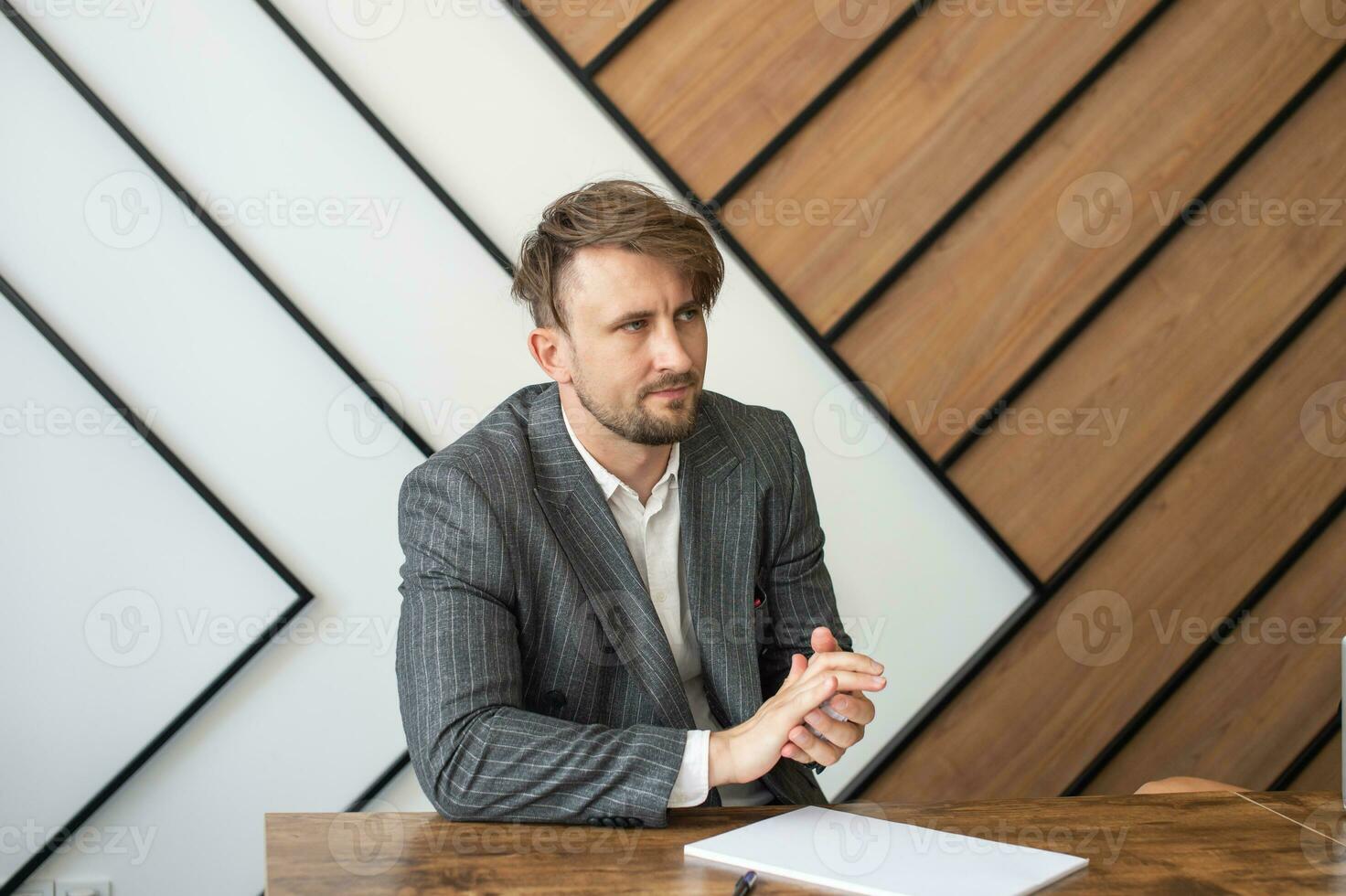 A bored concept at work, a tired unmotivated male employee wasting time in the workplace photo