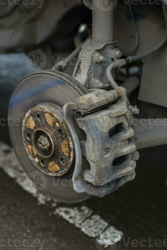 brake disc, caliper, pad hoses, and levers of the front let down the car photo