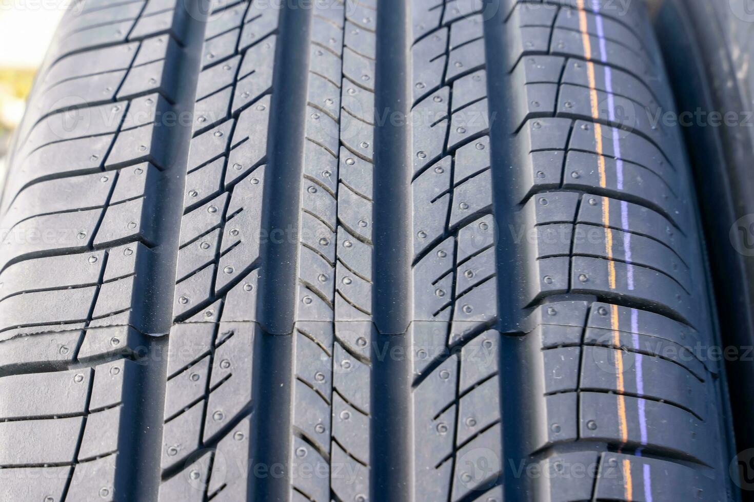 new car summer tires in a row. Car tire tread close-up. photo