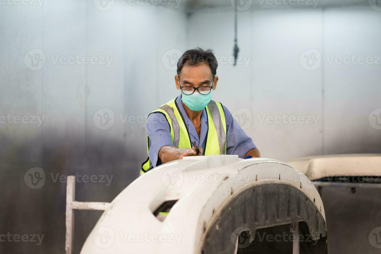 Senior mechanic man painting car in chamber, Technician checking the quality of the painting, Garage painting car service repair and maintenance photo